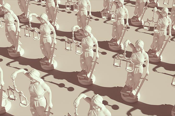 Marching Into 2026 on the Advocacy Frontline; Rows of beige colored Lady Justice statues holding scales and swords, casting strong shadows on a light surface, conveying order and solemnity.