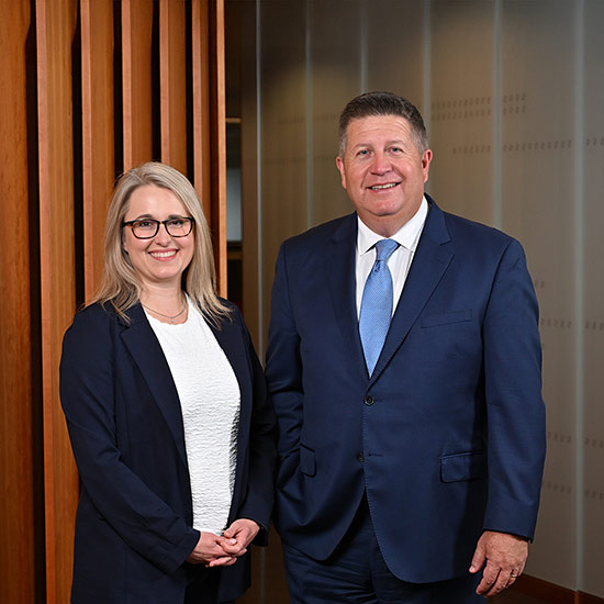 2026 Pub. 14 Issue 2 9 Man and woman in businesswear smiling